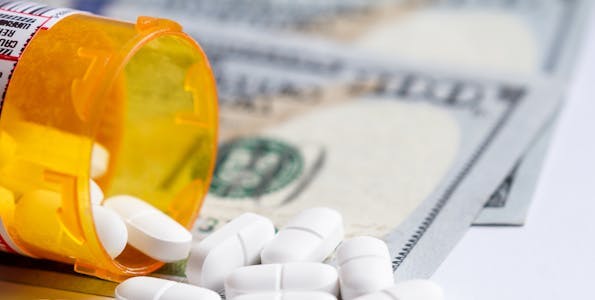 Prescription drugs and money representing the U.S. Healthcare system